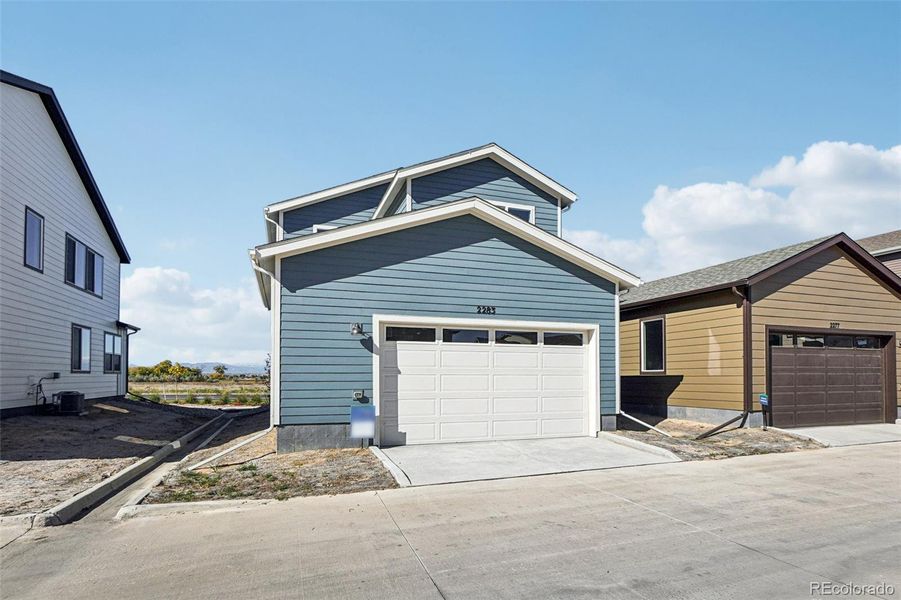 Exterior details and patio area of a home in Parkway at Prairie Center Village, Brighton (Image 3).