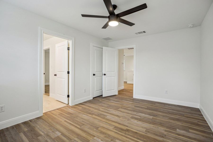 Bedroom 3 with visible vents, a ceiling fan, baseboards, and ensuite bathroom