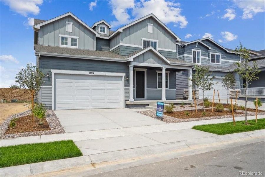 Front exterior of a new home in Farmlore, Brighton, CO, highlighting curb appeal (Image 13).