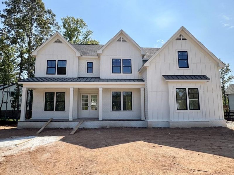 Front exterior of a new home in Arden on Lanier, Cumming, GA, highlighting curb appeal (Image 27). Front exterior of a new home in Arden on Lanier, Cumming, GA, highlighting curb appeal (Image 27).