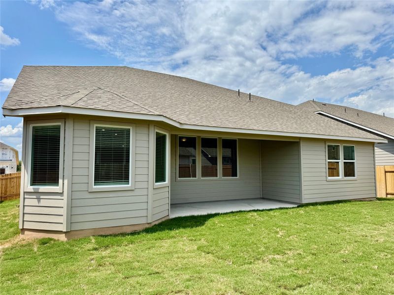 Rear view of property with a patio area and a shingled roof Rear view of property with a patio area and a shingled roof