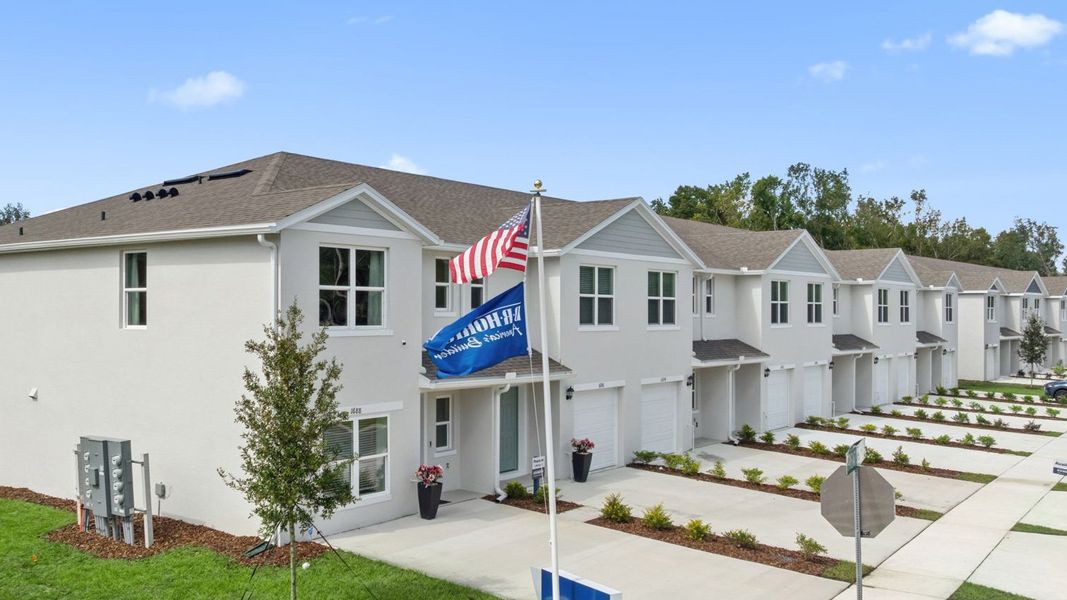 Front exterior of a new home in Sandalwood, New Smyrna Beach, FL, highlighting curb appeal (Image 1). Front exterior of a new home in Sandalwood, New Smyrna Beach, FL, highlighting curb appeal (Image 1).