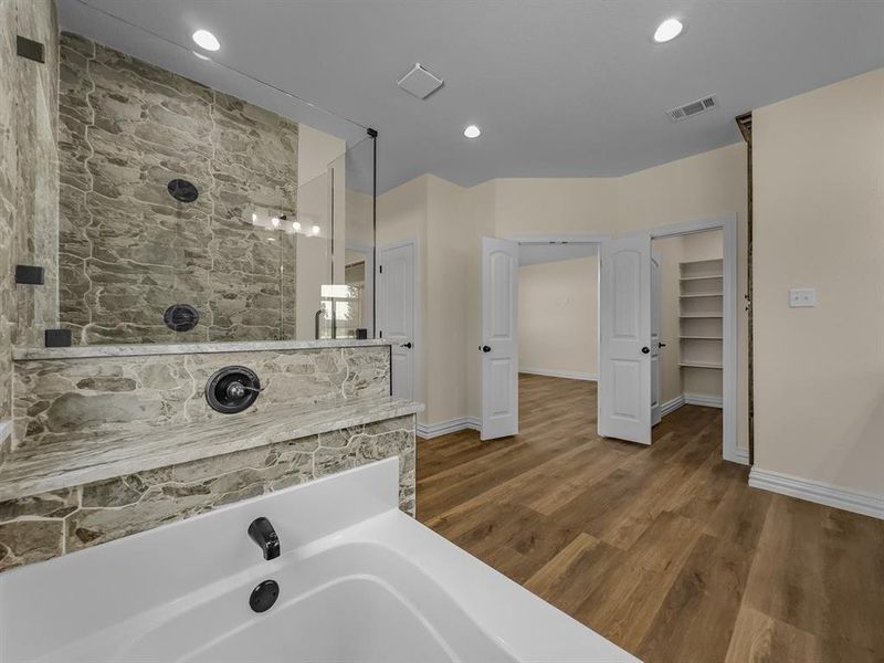 Full bath featuring wood finished floors, a bathtub, a shower, and recessed lighting Full bath featuring wood finished floors, a bathtub, a shower, and recessed lighting