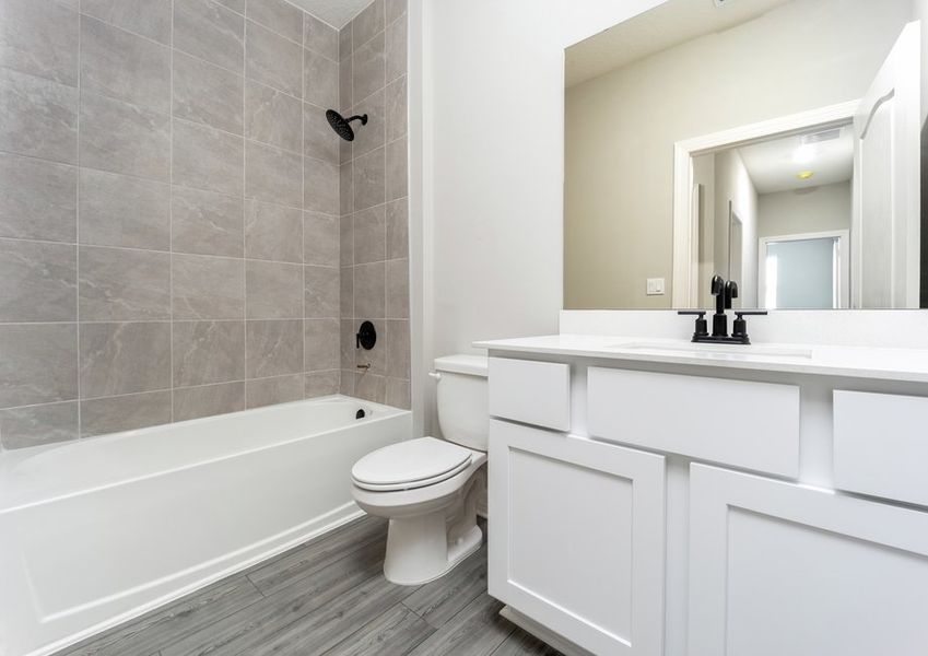 The spare bathroom has a spacious vanity and is ready to host your guests