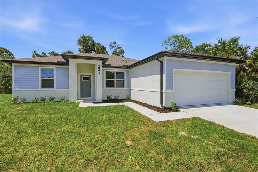 Front exterior of a new home in , North Port, FL, highlighting curb appeal (Image 1). Front exterior of a new home in , North Port, FL, highlighting curb appeal (Image 1).