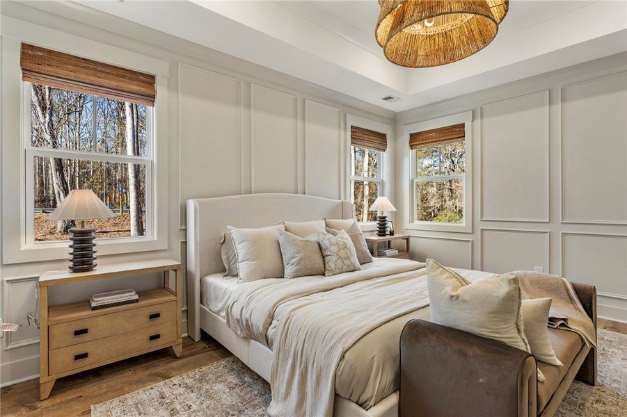This serene primary bedroom retreat features a tra