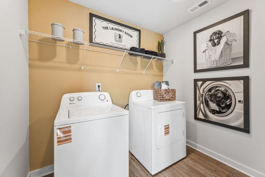 A laundry room with a washer and dryer. A laundry room with a washer and dryer.