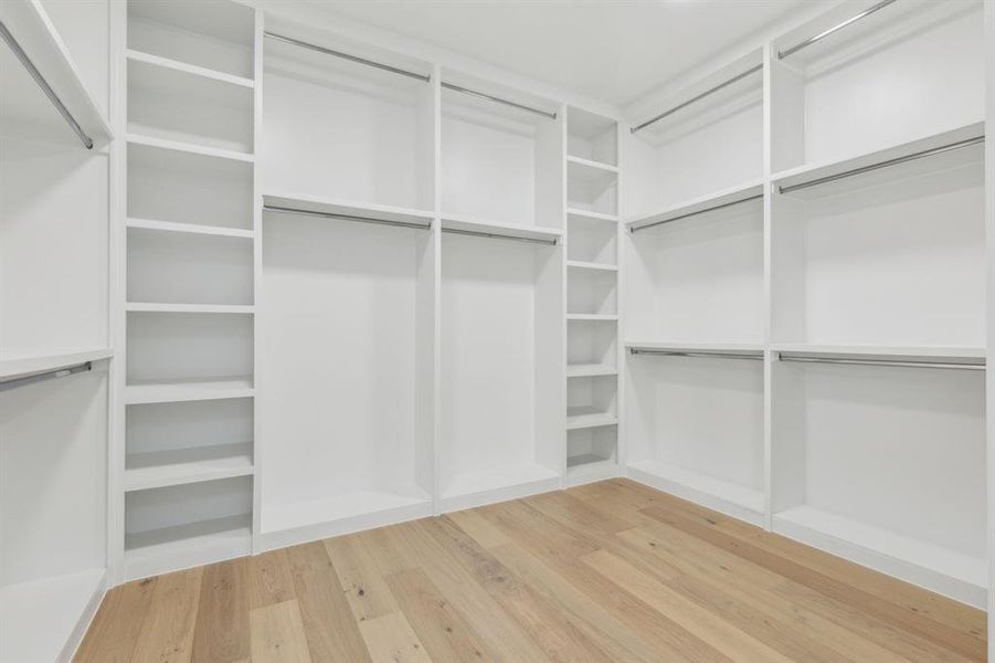 Spacious closet with hardwood / wood-style floors