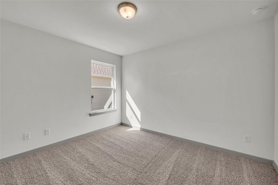 Spare room with carpet and baseboards