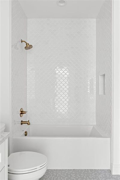 Full bath with bathtub / shower combination, vanity, and tile patterned floors