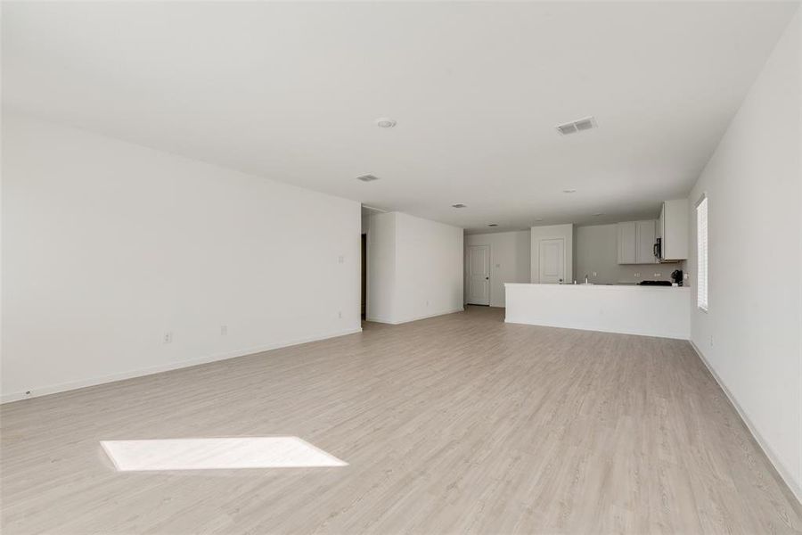 Unfurnished living room with light hardwood / wood-style floors