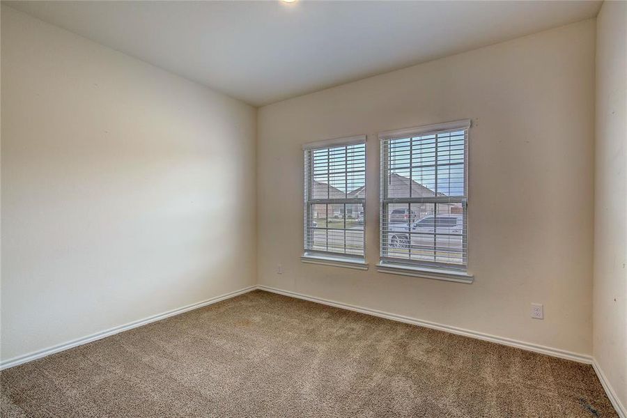 Carpeted empty room with baseboards