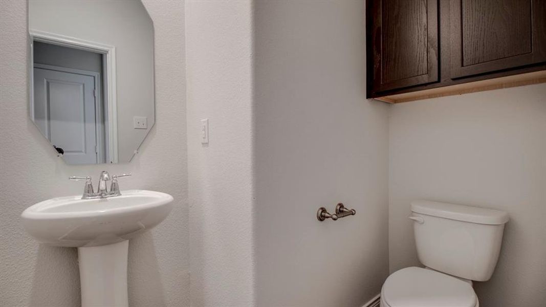 Half bath featuring toilet Half bath featuring toilet