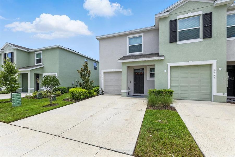 Front exterior of a new home in Westwood, Land O' Lakes, FL, highlighting curb appeal (Image 19). Front exterior of a new home in Westwood, Land O' Lakes, FL, highlighting curb appeal (Image 19).