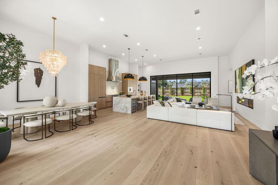 As you enter the home, a tremendous common area serves as a great entertaining space. Living, Dining & Kitchen areas are all expansive w/ 14 ft ceilings & a sliding wall of windows. Design selected fixtures throughout.