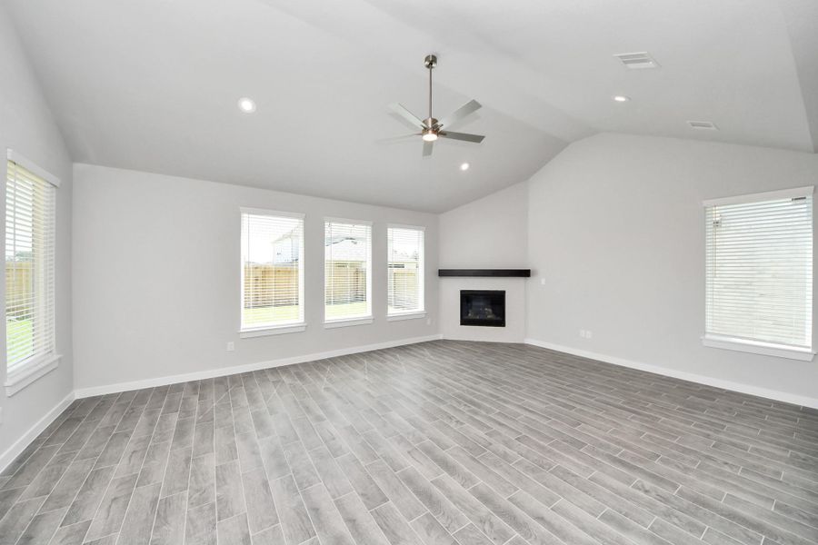 Welcome family and guests to your charming living room! With its high ceilings, recessed lighting, ceiling fan, custom paint, beautiful flooring, and large windows that let in abundant natural light, this room is perfect for gatherings. Sample photo of completed home with similar floor plan. Actual colors and selections may vary. Welcome family and guests to your charming living room! With its high ceilings, recessed lighting, ceiling fan, custom paint, beautiful flooring, and large windows that let in abundant natural light, this room is perfect for gatherings. Sample photo of completed home with similar floor plan. Actual colors and selections may vary.