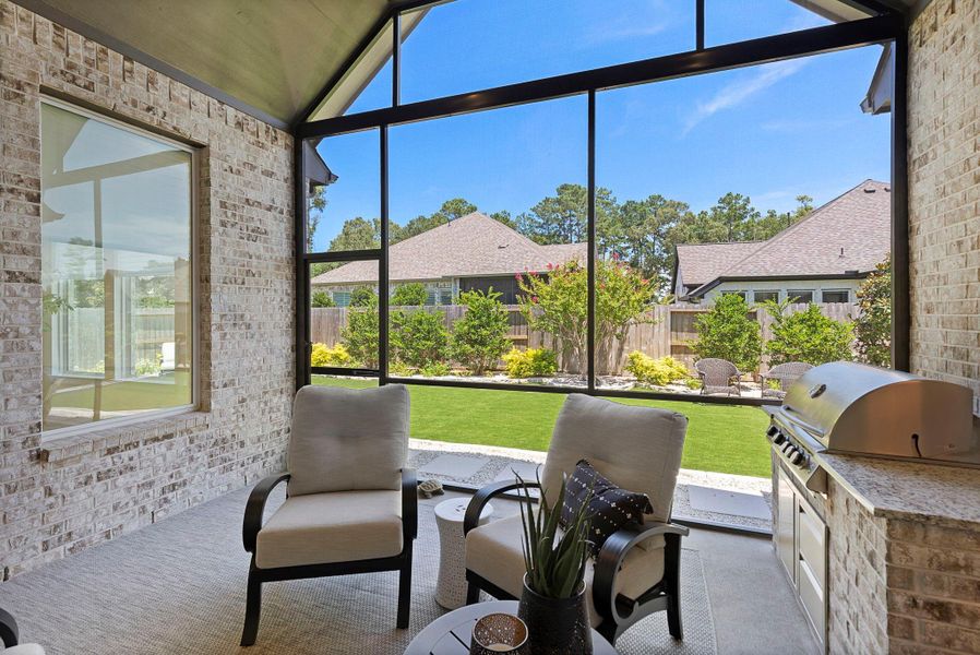 The custom summer kitchen enhances the outdoor living experience, perfect for weekend grilling or hosting gatherings!