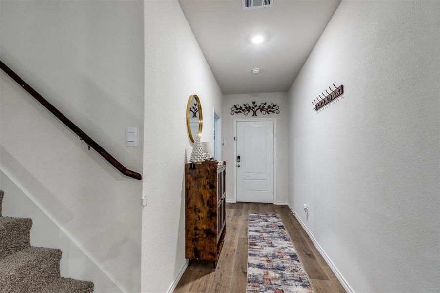 Doorway with wood finished floors and stairway Doorway with wood finished floors and stairway