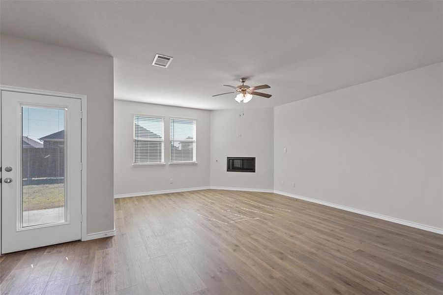 living room featuring hardwood / wood-style flooring and ceiling fan