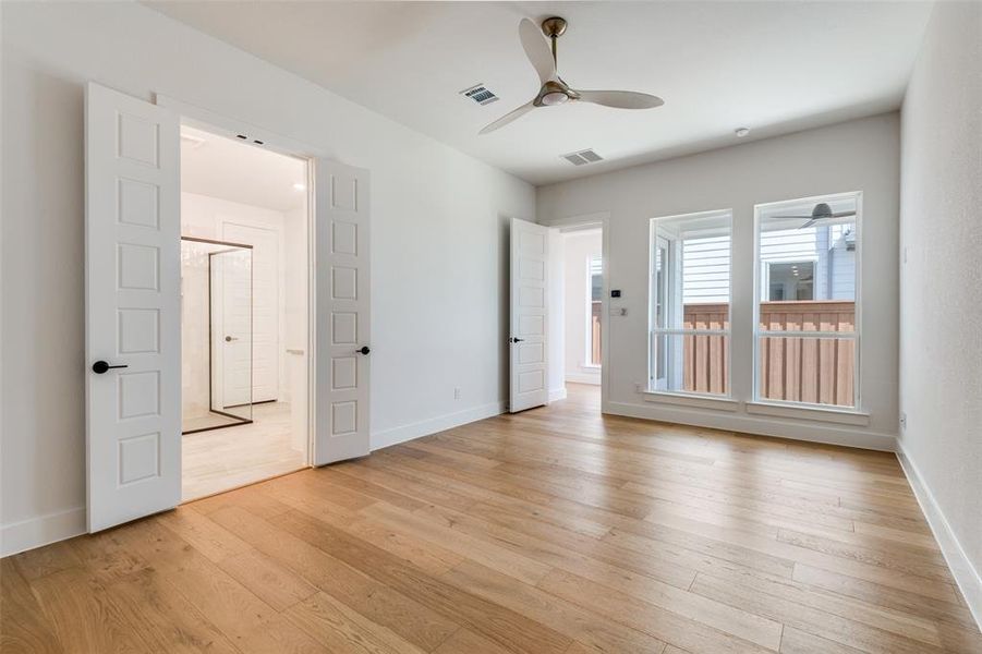 Unfurnished room with light wood-type flooring and ceiling fan