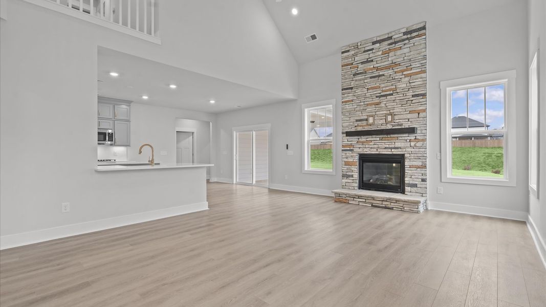 Tasteful family room with two-story volume, refined finishes, and exceptional natural light
