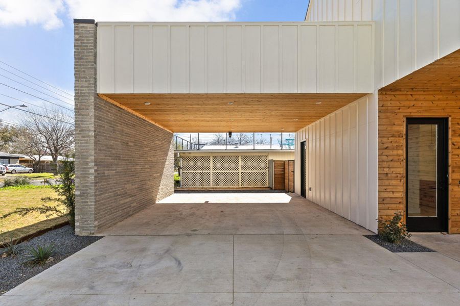 Garage with an attached carport and concrete driveway