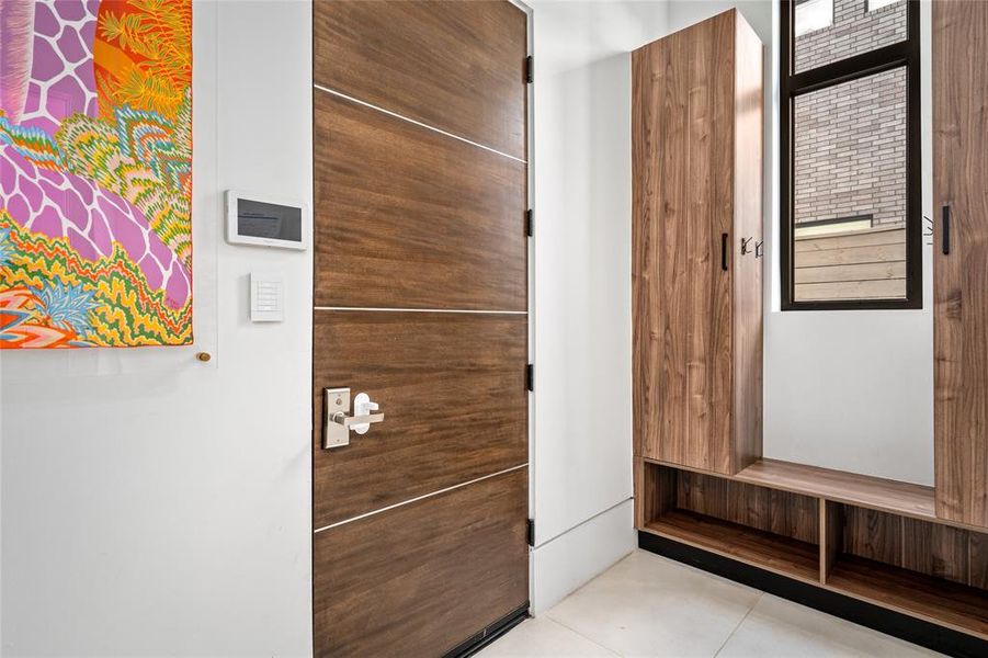 This well-organized mudroom offers both functionality and style with custom Madeval cabinetry providing ample storage for coats, bags, and shoes and perfect for keeping everyday items organized and out of sight.