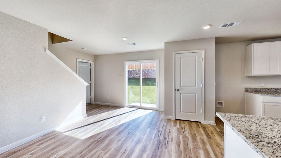 A room with a wood floor and a wood floor with a window.