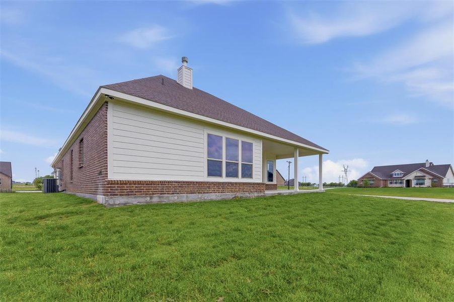 The property features a brick and siding exterior, a dark shingle roof, and a covered porch