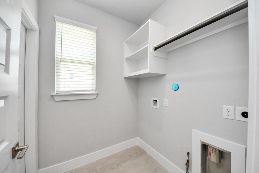 A perfect blend of functionality and comfort. Capture the essence of easy living with a first-floor laundry room, thoughtfully equipped with shelving for effortless organization. Both electric and gas connections available. A perfect blend of functionality and comfort. Capture the essence of easy living with a first-floor laundry room, thoughtfully equipped with shelving for effortless organization. Both electric and gas connections available.