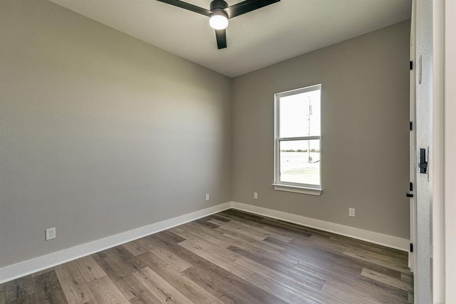 Spare room with ceiling fan and hardwood / wood-style floors