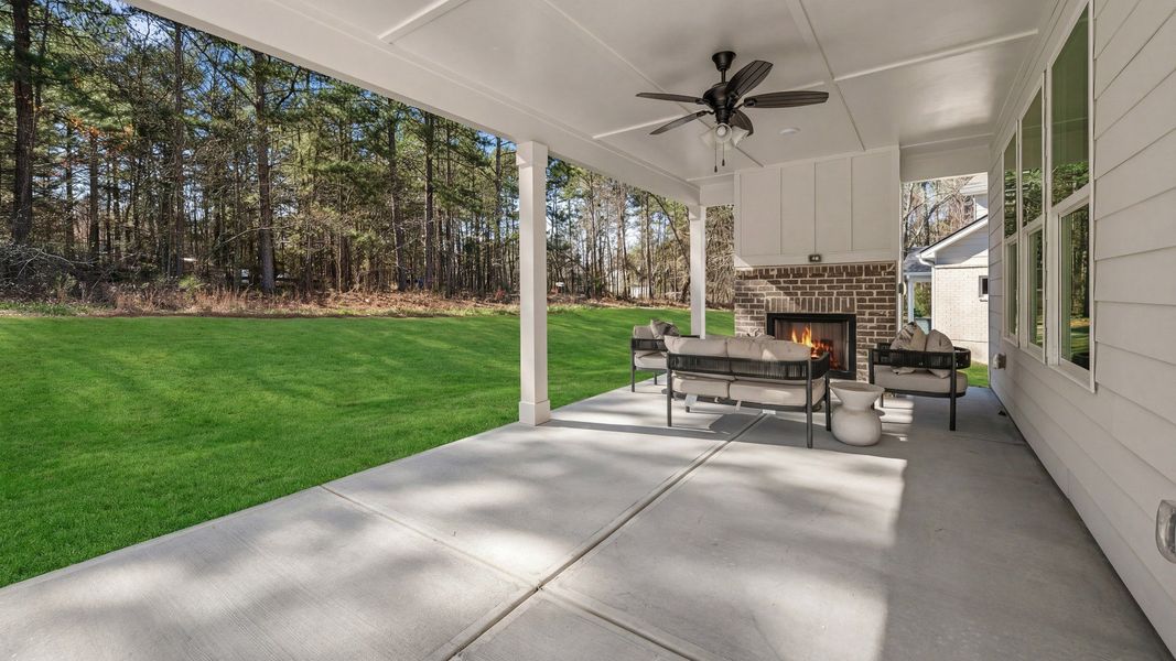 Spacious covered rear porch with fireplace Spacious covered rear porch with fireplace