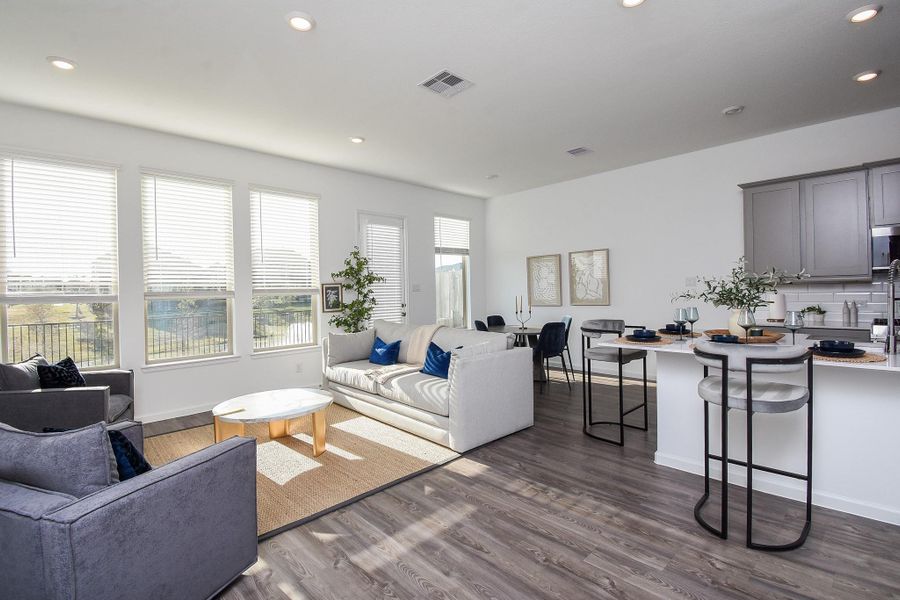 A cozy open-concept living area filled with natural light and ample seating space.