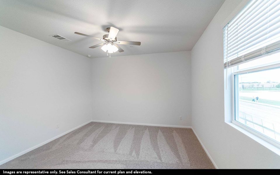 Spare room featuring light colored carpet and ceiling fan