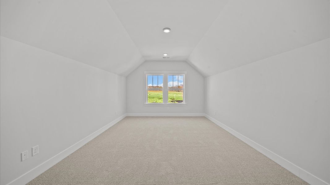 Accomplished upstairs bonus room with plush carpet and versatile functionality