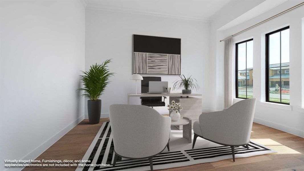 Home office with a healthy amount of sunlight, wood-type flooring, and ornamental molding