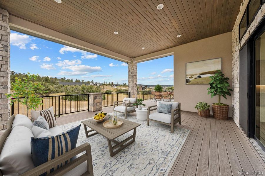 Virtually staged to inspire - the covered deck offers an inviting extension of the home with room for both lounging and dining, set against scenic Colorado views.