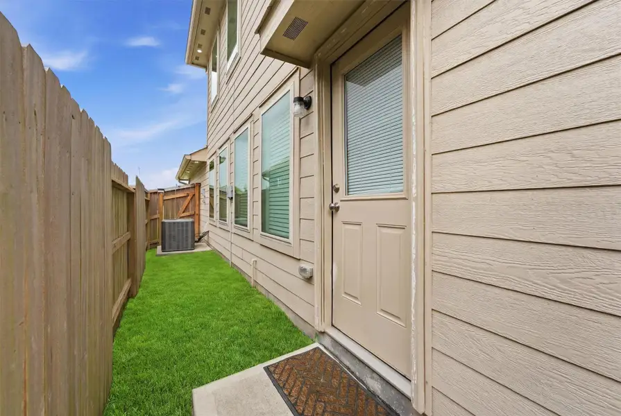 Exterior details and patio area of a home in Pinewood at Grand Texas, New Caney (Image 22).