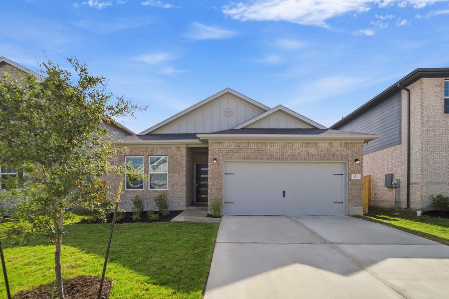 Front exterior of a new home in Sunfield, Buda, TX, highlighting curb appeal (Image 1). Front exterior of a new home in Sunfield, Buda, TX, highlighting curb appeal (Image 1).
