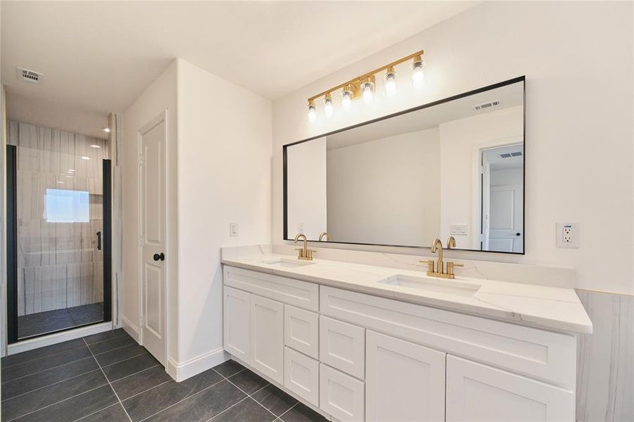 Bathroom featuring walk in shower, tile patterned flooring, and vanity