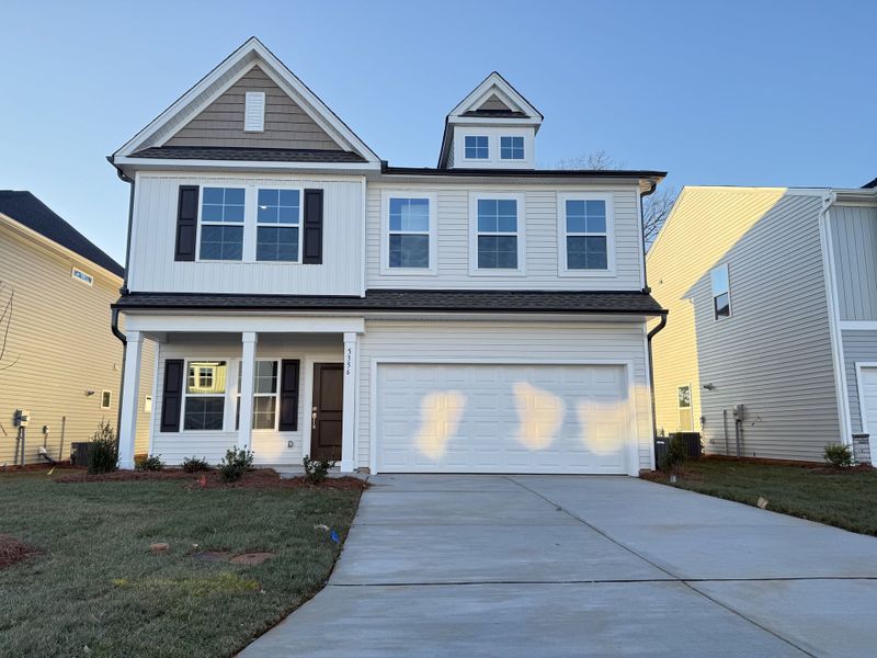 Front exterior of a new home in Hanes Lake, Winston-Salem, NC, highlighting curb appeal (Image 1). Front exterior of a new home in Hanes Lake, Winston-Salem, NC, highlighting curb appeal (Image 1).