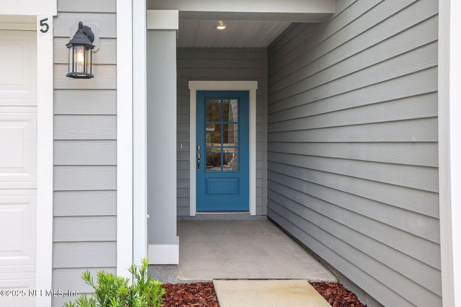 Front exterior of a new home in The Hammock at Palm Harbor, Palm Coast, FL, highlighting curb appeal (Image 15).