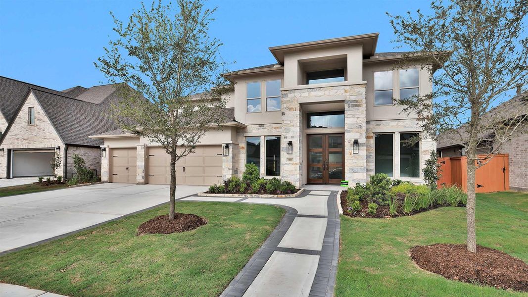 Front exterior of a new home in Elyson, Katy, TX, highlighting curb appeal (Image 2). Front exterior of a new home in Elyson, Katy, TX, highlighting curb appeal (Image 2).