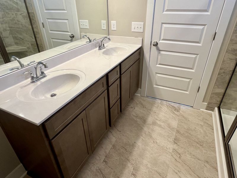 Actual home in owner's suite with tile and raised double vanities Actual home in owner's suite with tile and raised double vanities