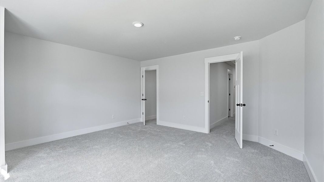 Elegant bedroom retreat featuring soft carpeting and a thoughtfully designed walk-in closet at Barton Hollow