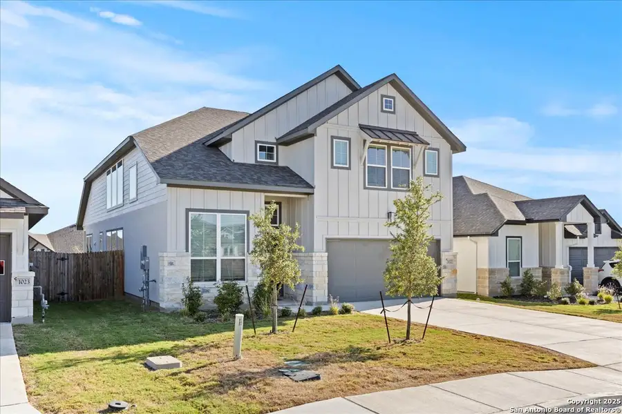 Front exterior of a new home in August Fields, New Braunfels, TX, highlighting curb appeal (Image 1).