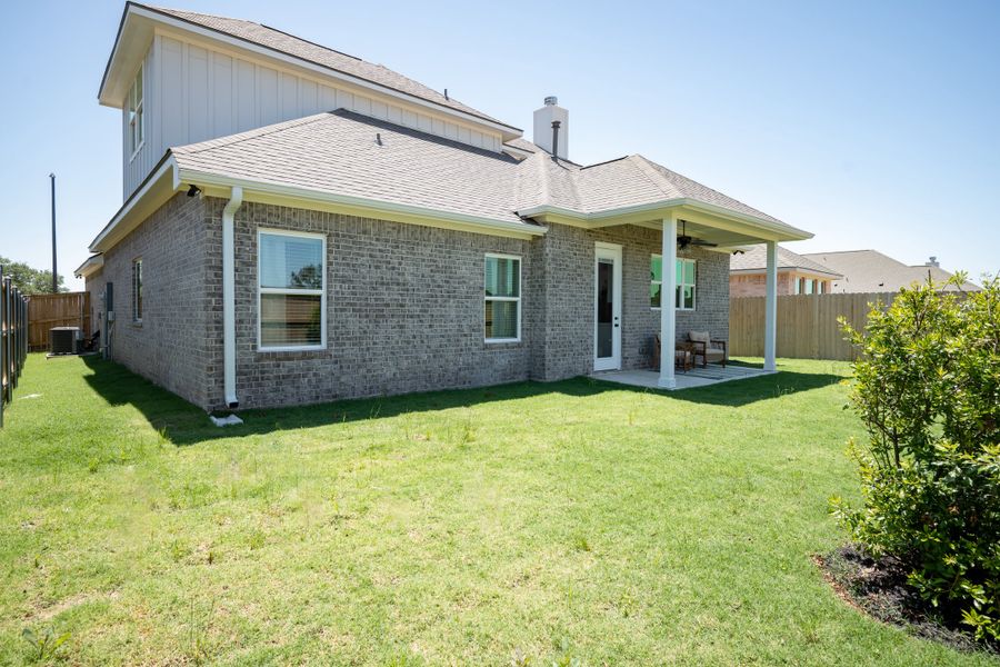Front exterior of a new home in Greens Prairie Reserve, College Station, TX, highlighting curb appeal (Image 23).