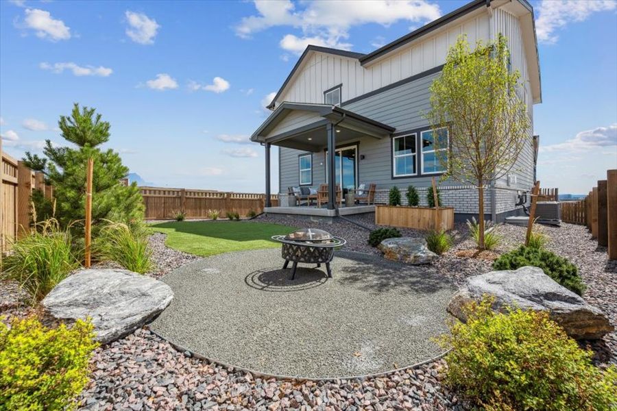 A backyard with a table and a grill.