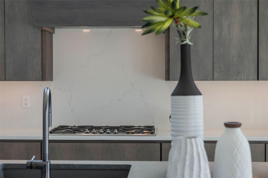 Kitchen view of stainless steel gas stovetop
