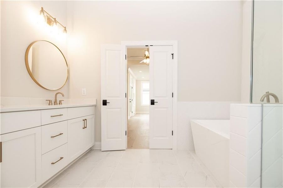 Primary bathroom gives you a peaceful space to relax and unwind from busy days.  Image soaking in the deep tub. Inage is of previously built plan.